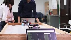 Teenage works on a fully functional programable Robot for his school robotics club project.Creative designer testing robotics prototype in workshop.Science concept Stock Footage