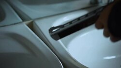 Stressed bandit putting handgun on sink and looking into mirror after crime Stock Footage