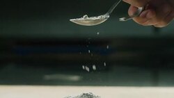in an Italian professional kitchen a chef pours salt on a dish or in the water to boil the Italian pasta concept of healthy and light food. Stock Footage