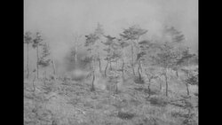 During Korean War, clouds of dust as South Korean gunfire hits slope during Battle of Bloody Ridge in North Korea News Clip