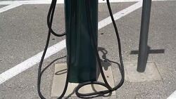 panning from concrete up to Electric Car charging station Stock Footage