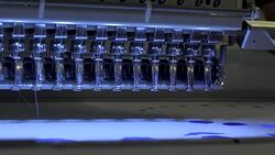 Automatic modern sewing machine embroider a pattern,Industrial embroidery equipment. Textile Manufacturers.Industrial textile factory,Textile Factory. Textile Industry. Stock Footage