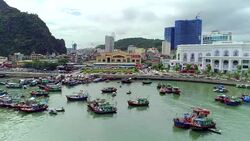 4k Aerial view over city and park with Bai Tho karst mountain Ha long bay. Halong City. Stock Footage