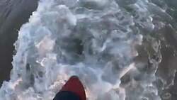 Feet with wave on sandy beach top view slow motion Stock Footage