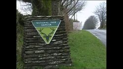 Exmoor National Park with foot and mouth notification sign at roadside News Clip