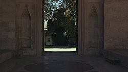 WIDE ANGLE OF ENTRANCE TO STONE COURTYARD. ISLAMIC ARCHITECTURE. COULD BE SULEYMANIYE MOSQUE. POV FROM INSIDE. Stock Footage