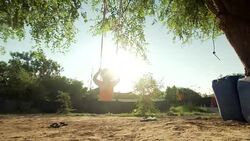 Shot of a Palestinian child on a swing in the village of Khan al-Ahmar, West Bank Stock Footage