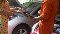 Woman giving keys from car to mechanic Stock Footage