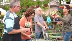 Family shop for plants with Salesman at Flower Market Stock Footage