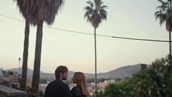 Happy couple on vacations. Old town panorama in background Stock Footage