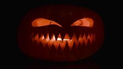 Pumpkin with a carved angry face and teeth. Stock Footage
