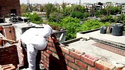 Bricklayer installing bricks on construction site Stock Footage