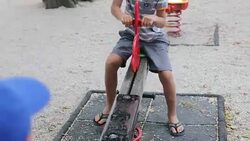 Kids playing on teeter totter Stock Footage