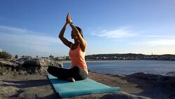 Beautiful view of the sea and woman practicing lotus position on the cliff Stock Footage