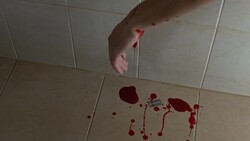 Person committed suicide with sharp blade in bath, blood splash on tile floor Stock Footage