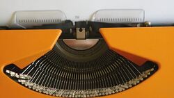 High angle shot of a person writing TERRORISM on an old typewriter, with sound Stock Footage
