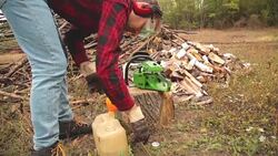 Lumberjack fixing / maintain the chainsaw outdoors. Stock Footage