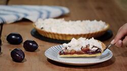 Delicious sliced cake of ripe plums close-up on the table. Stock Footage