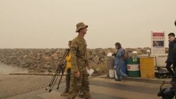 soldiers help load evacuees on to evacuation boat News Clip