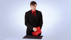 How to Do the Coin thru the Handkerchief Magic Trick Instructional Video