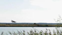 Antonov An-2 for spraying of fertilizers and pesticides on the field. Stock Footage