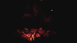 Scary witch does voodoo black magic ritual near the fire at night. Halloween horror Stock Footage