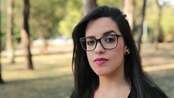 Young brunette woman wearing feminist glasses with a serious look expression on face looking camera Stock Footage