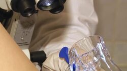 Close up of female doctor gynecologist in blue gloves holding plastic gynecological mirror in gynecological room at medical center. Unrecognizable female doctor gynecologist working with patient. Vaginal Smear. Stock Footage