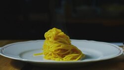 Super slow motion macro of a middle aged chef decorating pasta dish with yellow tomatoes on a white plate (close up) Stock Footage