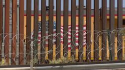 CLEAN : US reinforces its border fence with Mexico with barbed wire News Clip