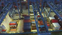 Loading Cargo Containers into Ship in Industrial Port at Night, Close-up Shot Stock Footage