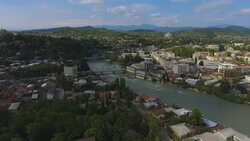 Large green Kutaisi city in Georgia aerial view, Rioni river and mountains Stock Footage