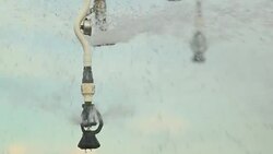 Pivot irrigation system in 4K 60fps. Close-up of pivot sprinkler system irrigating crops. Irrigation pivot system watering agriculture field Stock Footage