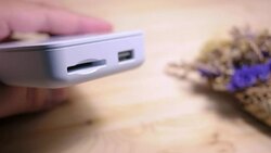 Close-up of a man's hand is plugging a micro sd card into the reader to retrieve the data with soft focus scene. Stock Footage