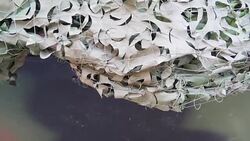 A camouflage cloth covering the military tanks Stock Footage