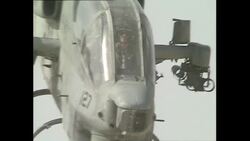 Cobra attack helicopter flying over desert News Clip