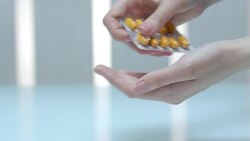Female hand take medicaments dose. Close up of woman pour tablet from blister Stock Footage