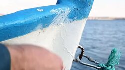 Fisher paints fishing boat Stock Footage