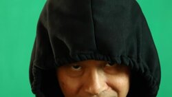 Thai man in hood with green background Stock Footage