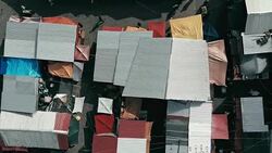 aerial drone footage of the morning city market with colorful tents looking down Stock Footage