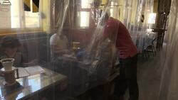 Cafe owner uses shower curtains for social distancing News Clip