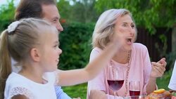 Friendly family communicating and laughing having lunch outdoor pleasure pastime Stock Footage