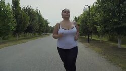 Fat girl runs along the road Stock Footage
