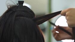Beautiful girl does a hairstyle in a beauty salon Stock Footage