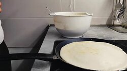 Woman waiting by the stove while pancake is frying Stock Footage