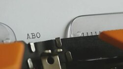 Close up footage of a person writing ABORTION on an old typewriter, with sound Stock Footage