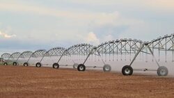 Pivot sprinkler system irrigating crops. Irrigation pivot system watering agriculture field in 4K 60fps Stock Footage