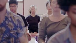 Serene creative business people meditating in office Stock Footage