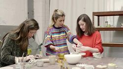 Teacher guiding students in making pottery Stock Footage