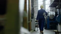 Factory Worker Carrying Rolled Blueprints Stock Footage
